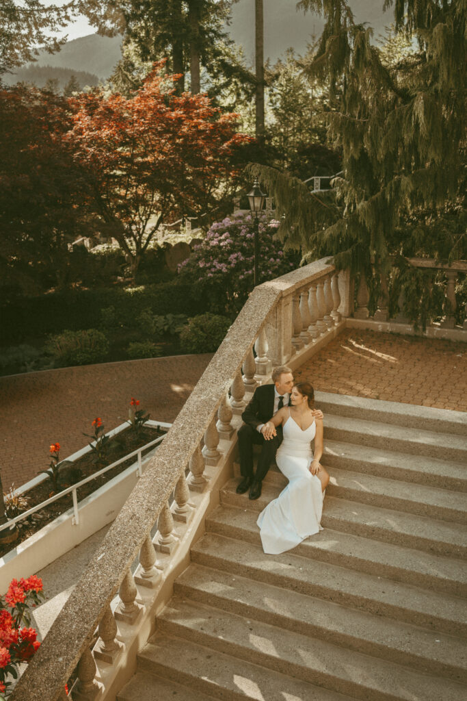 Wedding Couple Sitting on the Grand Stairs At Swaneset Bay
