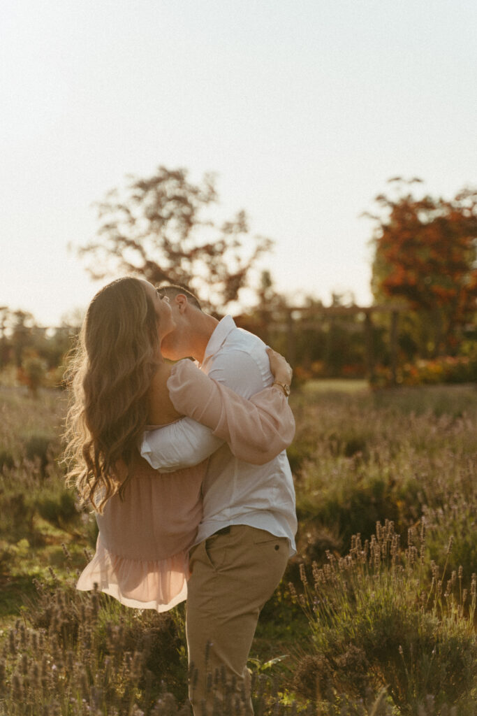 whimsical engaged couple in a lavender field