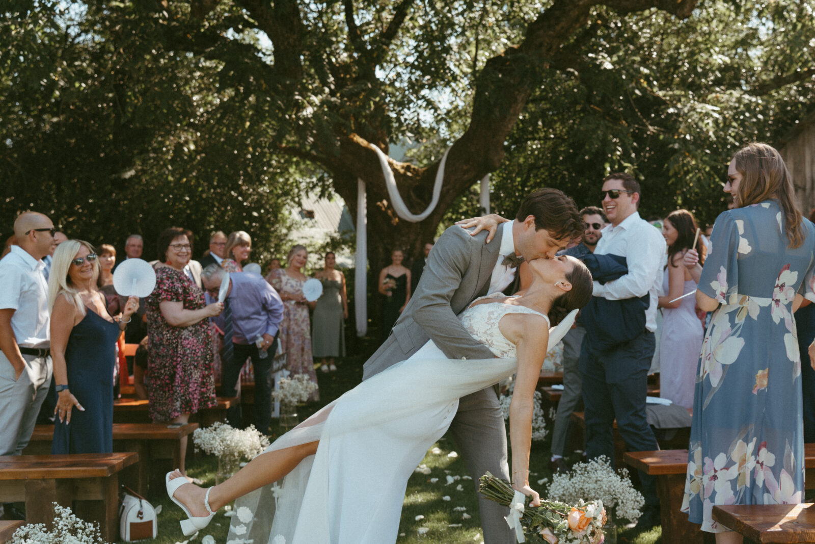 bride and groom dipping for a kiss down the aisle at Estate 248 wedding ceremony