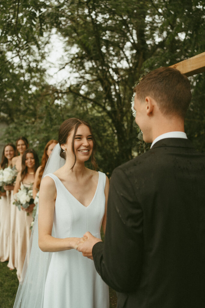 bride and groom holding hands at the altar