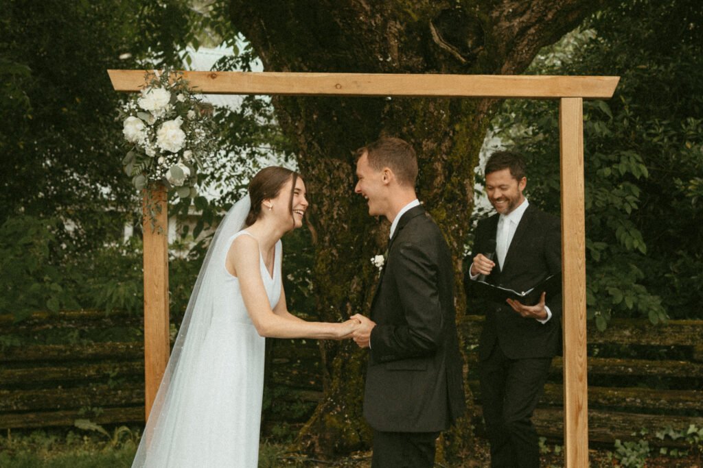 bride and groom holding hands at the altar