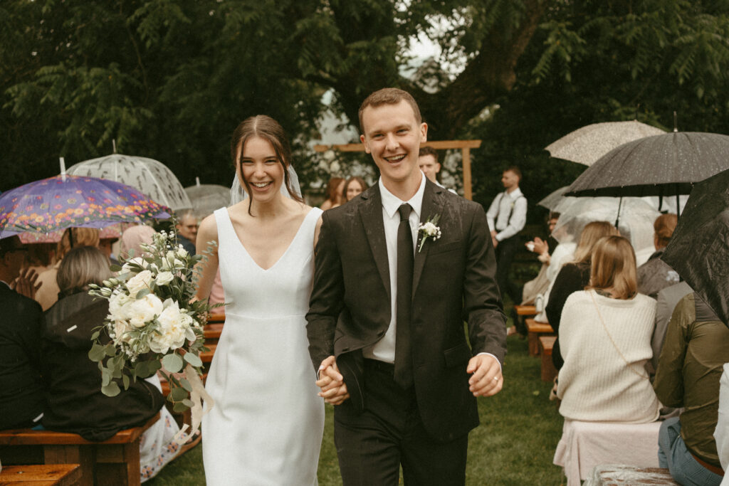 rainy wedding ceremony on the lawn at Estate 248