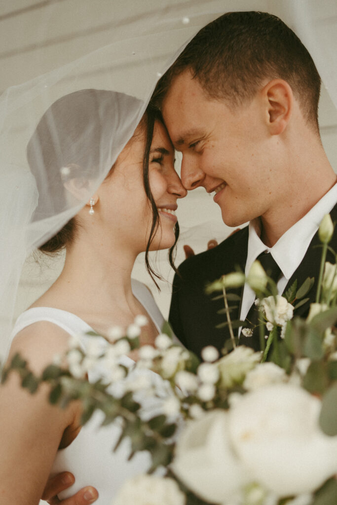 bride and groom under the veil