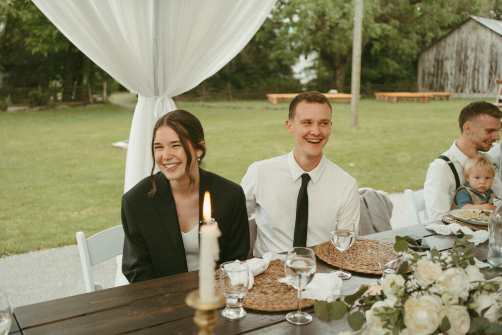 bride and groom listening to speeches