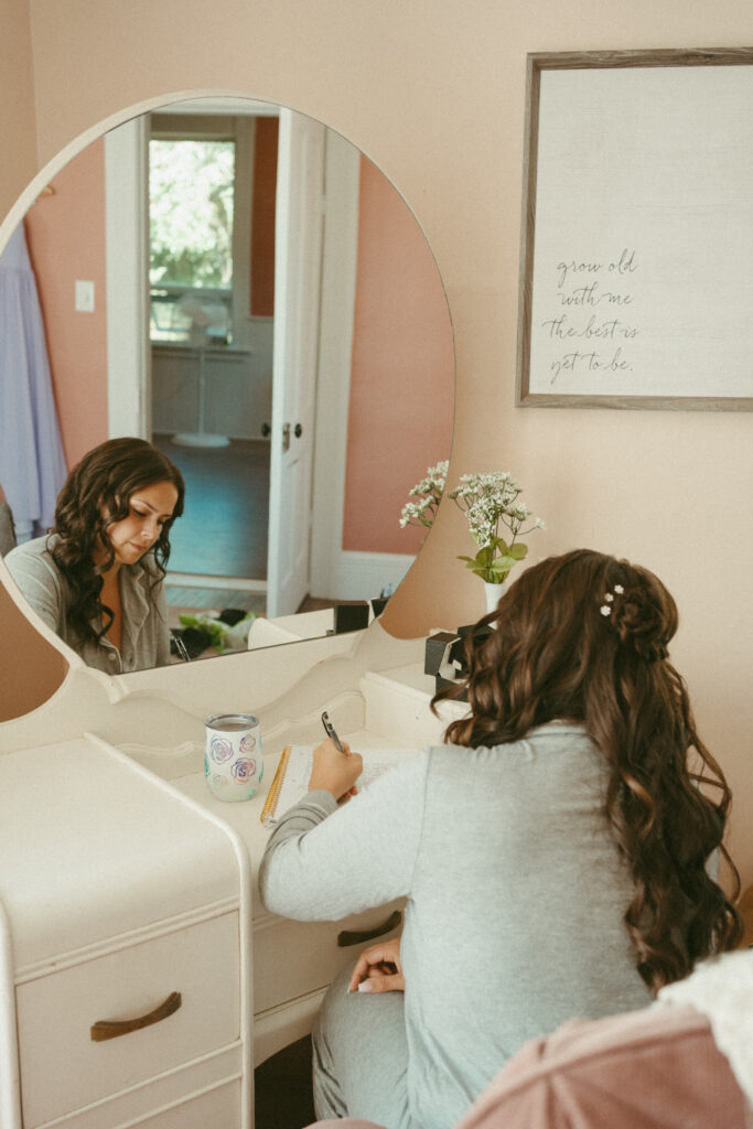 Bride writing love letter to groom