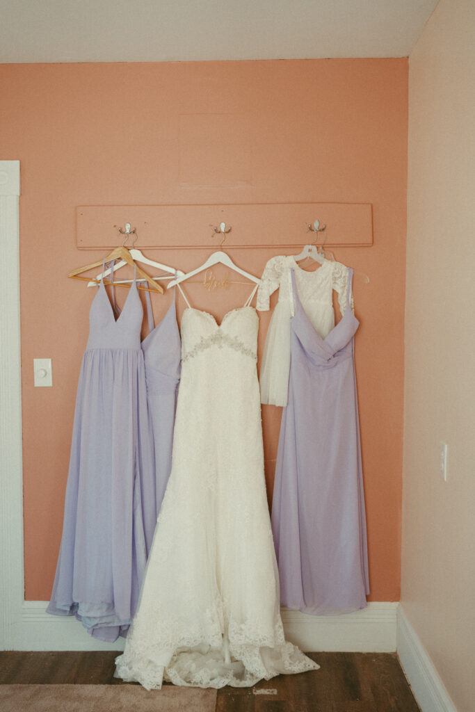 bridal gown and bridesmaids dresses hanging