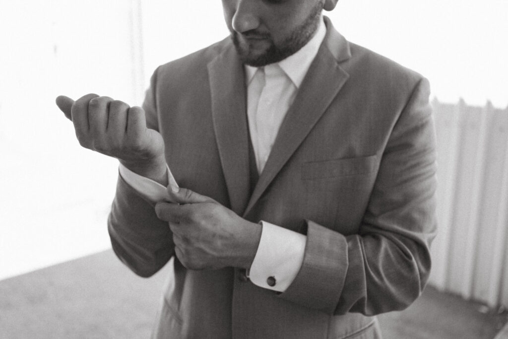 groom getting ready, fixing cufflinks