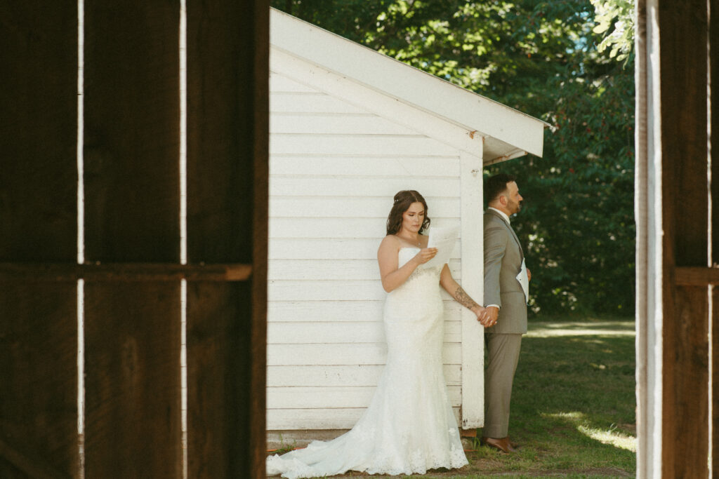 bride and groom reading private vows to each other