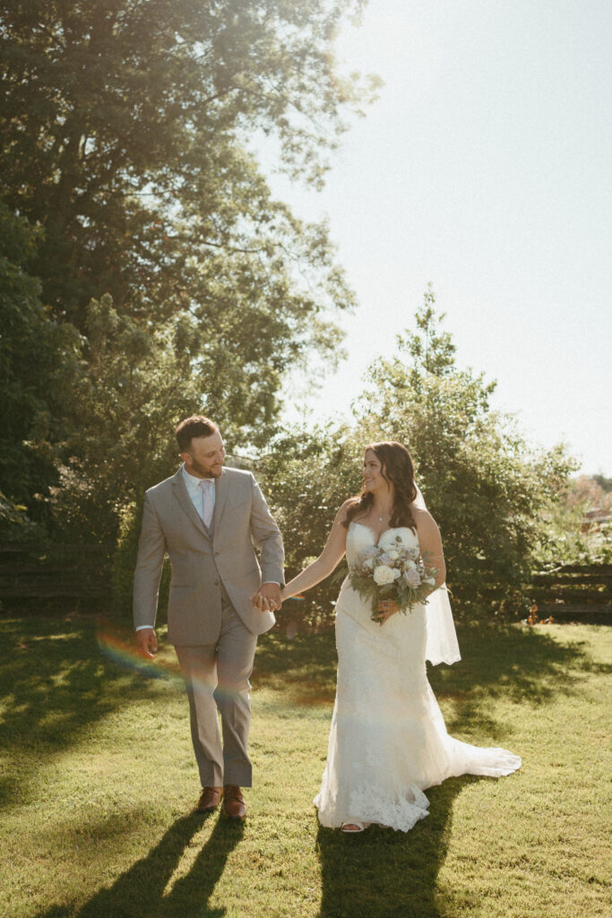 bridal couple walking hand in hand at Estate 248