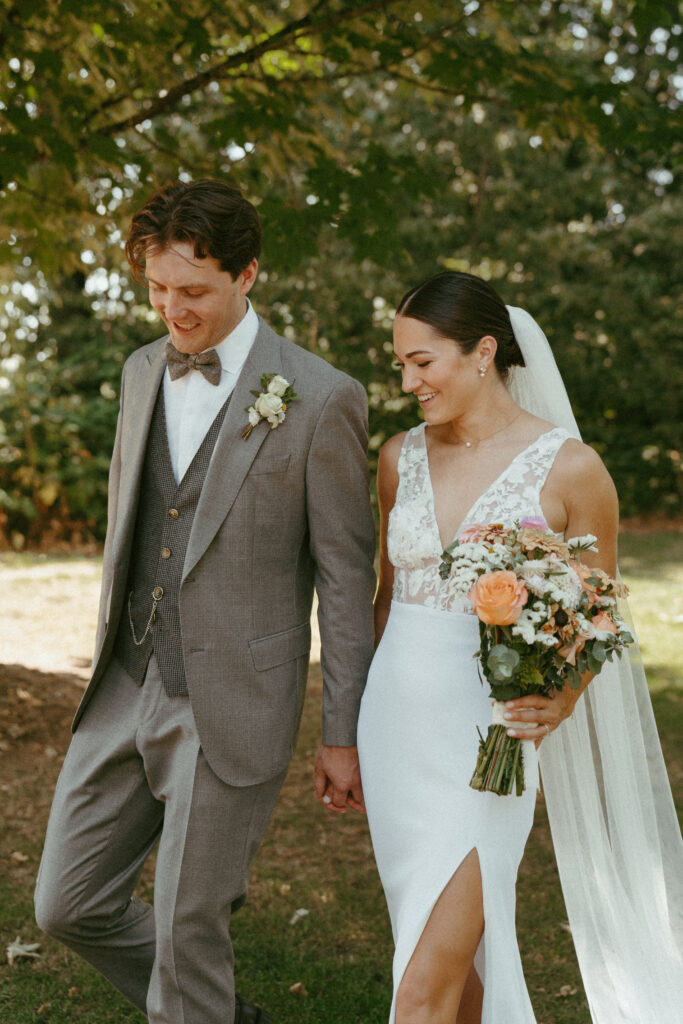 bride and groom holding hands walking