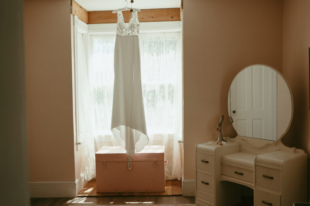 bridal gown hanging in the getting ready room 