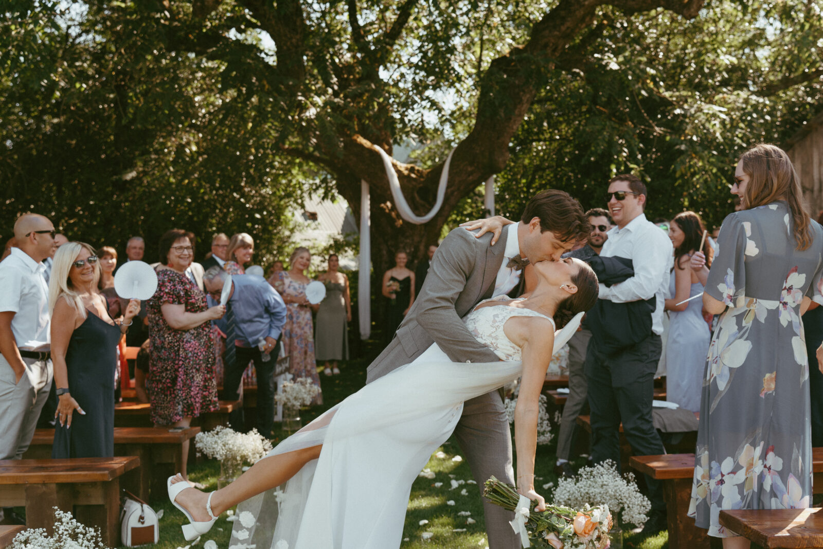 bride and groom dipping for a kiss down the aisle at Estate 248 wedding ceremony