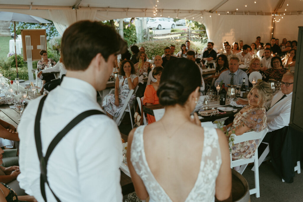 bride and groom giving speech to guests